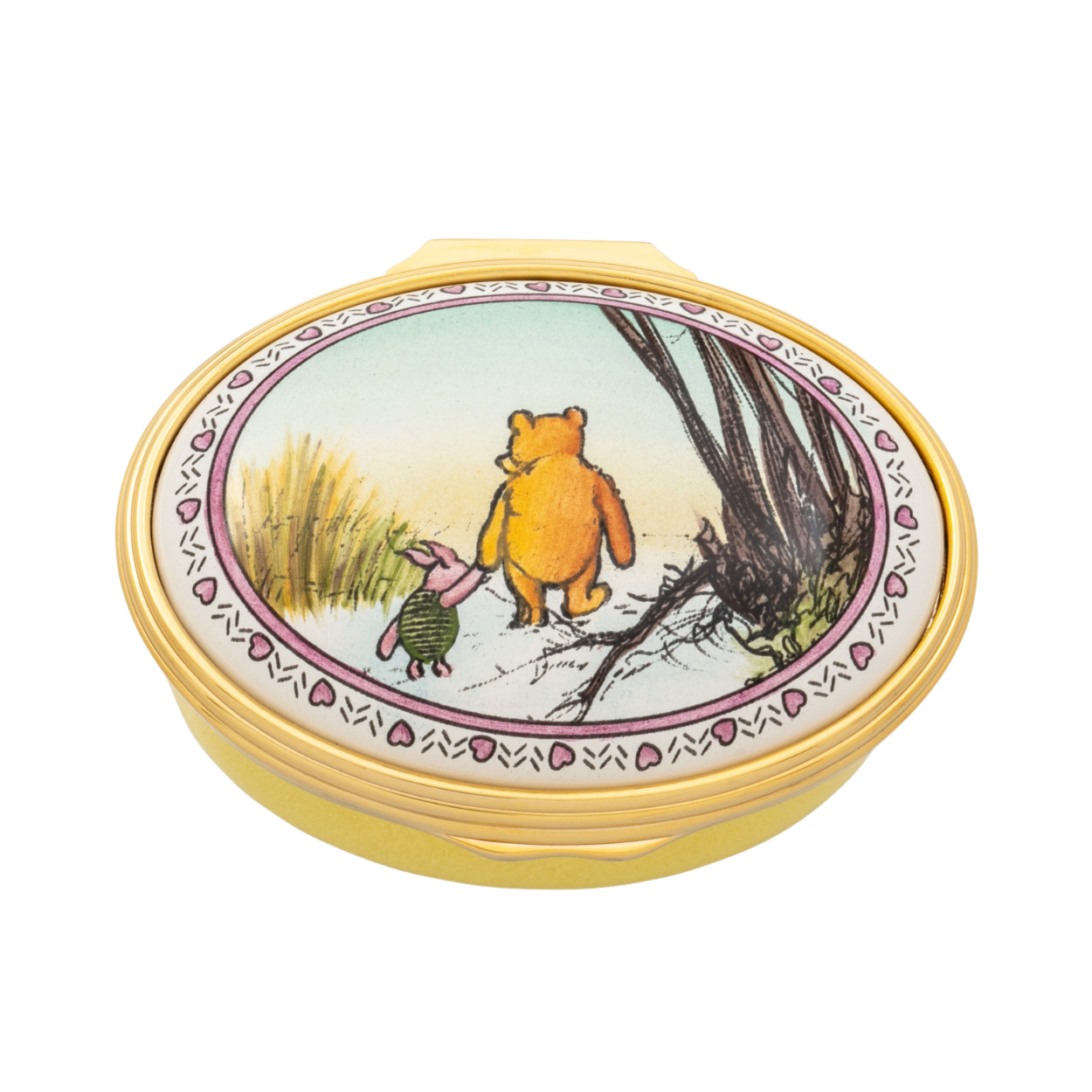 A round gold-toned keepsake box with a hinged lid, featuring a colorful illustration of Winnie the Pooh and Piglet on the lid, set against a plain white background.